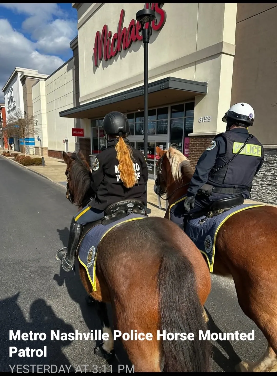 Mounted police patrol near a Michaels store.