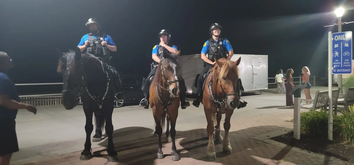 Mounted police officers on nighttime patrol.